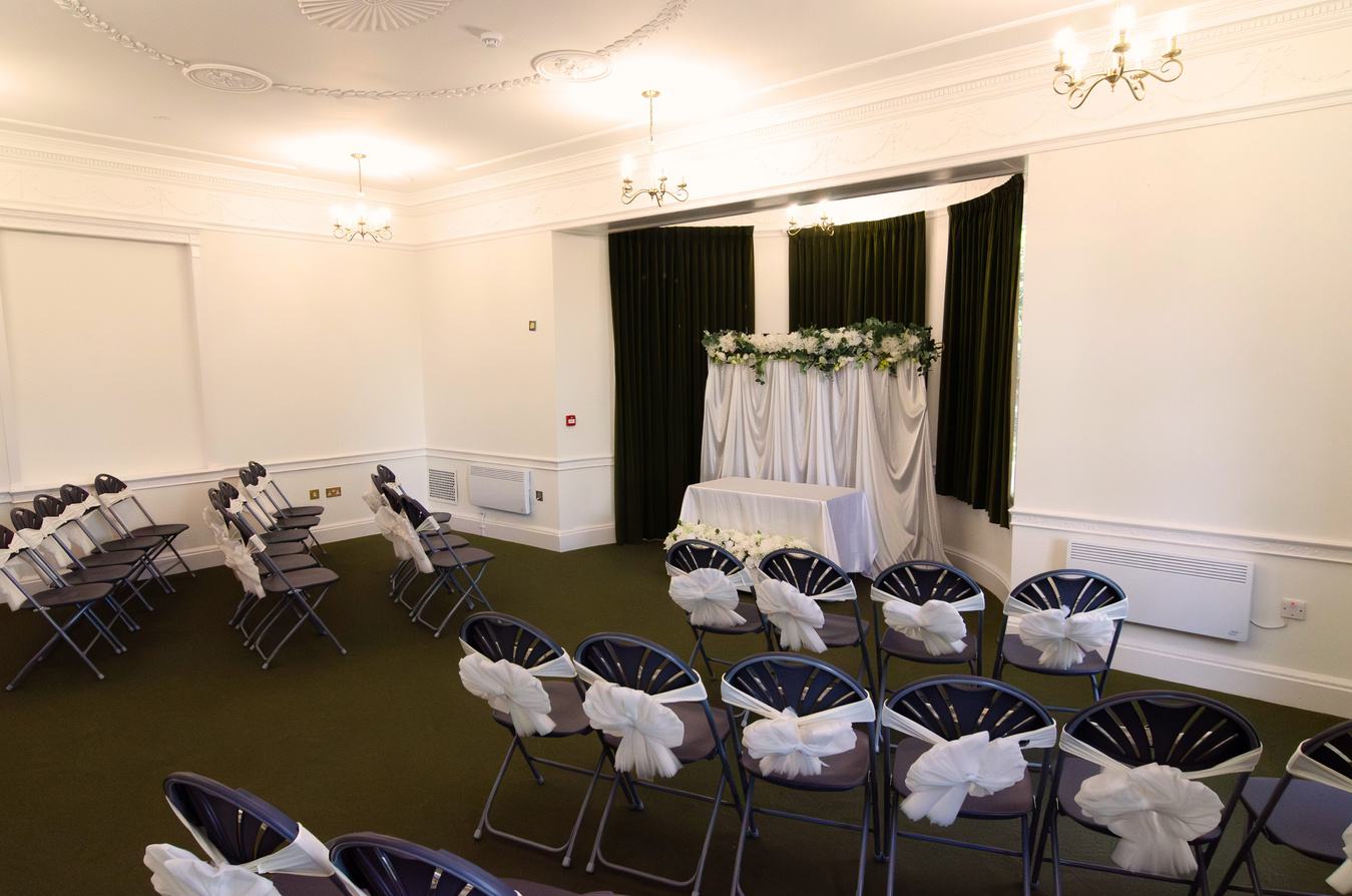 a wedding ceremony room with chairs and tables set up for the ceremony